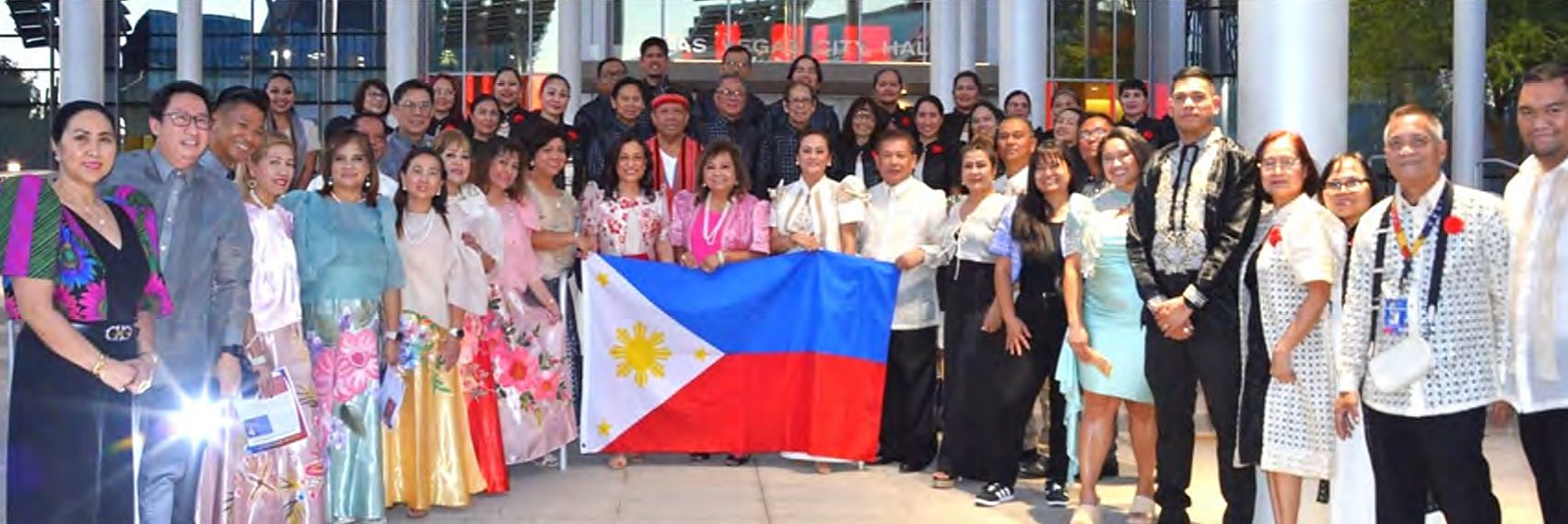 Filipino American community leaders hold a Philippine flag outside Las Vegas City Hall at the Filipino American History Month lighting