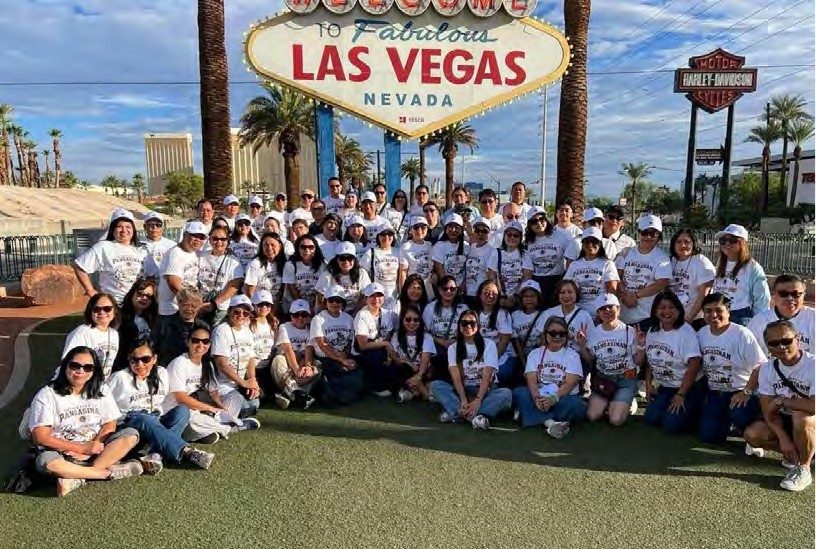 Dozens of University of Pangasinan Nursing Class of 1993 alumni in matching reunion shirts pose at the Welcome to Fabulous Las Vegas sign