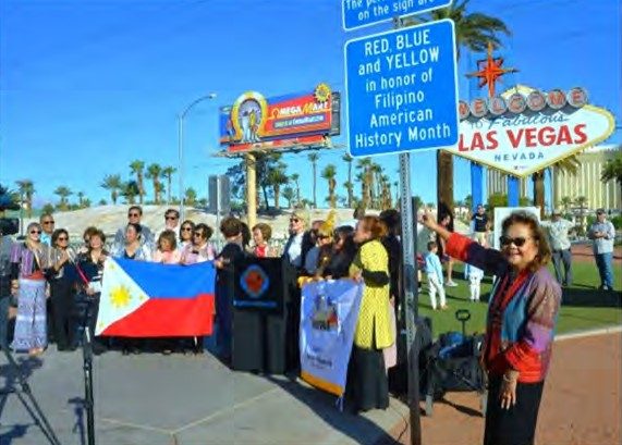 A notice near the Welcome to Fabulous Las Vegas sign says its perimeter lights are red, blue and yellow in honor of Filipino American History Month